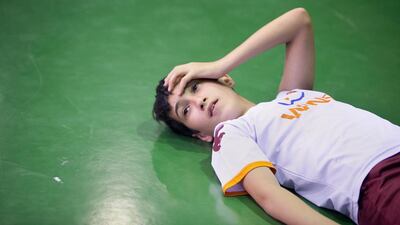Osama Mahmoud, 12, takes a break from Brazilian Jiu-jitsu practice at the Abdullah Bin Otaiba School in Madinat Zayed, Abu Dhabi city.