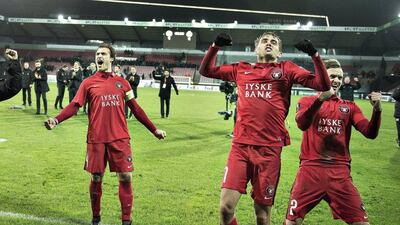 Erik Sviatchenko, left, Jakob Poulsen and Kian Hansen of Midtjylland celebrate after the match against Club Brugge in the Uefa Europa League group D match in Herning, Denmark December 10, 2015. REUTERS/Henning Bagger
