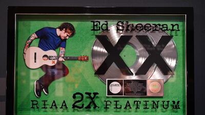 The exhibition charts his musical success, displaying an award for 2x platinum record sales for album 'X'.