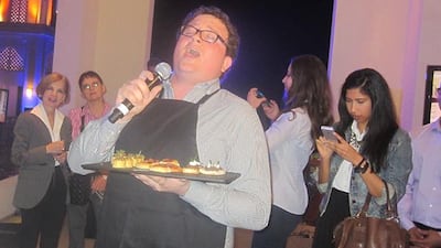 An opera singer with a plate of appetisers marks the opening of Carluccio's at the Eastern Mangroves Promenade.