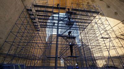 Conservation workers stand on the scaffolding at the Arch of Ctesiphon.