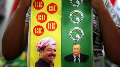 A street vendor in Erbil holds banners depicting Kurdistan pesident Massud Barzani and Iraqi president Jalal Talabani before Iraqi elections in April. A reader says it is time for Iraqi Kurds to get full independence. Safin Hamed / AFP