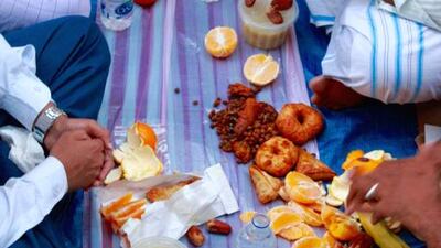 Muslims waiting to break their fast by Perryhan El_Ashmawi (the food is donated by the Indian Muslim Society.Courtesy Frying Pan Adventures and Gulf Photo Plus