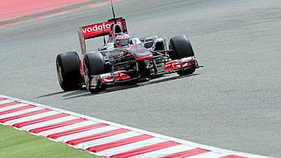 Jenson Button, the McLaren-Mercedes driver, tests out his car at the Circuit de Catalunya near Barcelona yesterday. Josep Lago / AFP