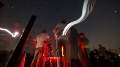 People gather to watch the Perseids meteor shower at Al Khatim Desert in Abu Dhabi, United Arab Emirates. The Dubai Astronomy Group organized the overnight event, which included a talk about the Perseids, a sky-mapping session, a question-and-answer session and telescope observations. EPA