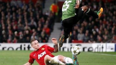 Alexander Buttner, left, the Manchester United player, tackles Braga's Leandro Salino during their Champions League match at Old Trafford last night. Jon Super / AP Photo