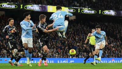 City attacker Phil Foden slots home the third goal to earn his team three points. Reuters