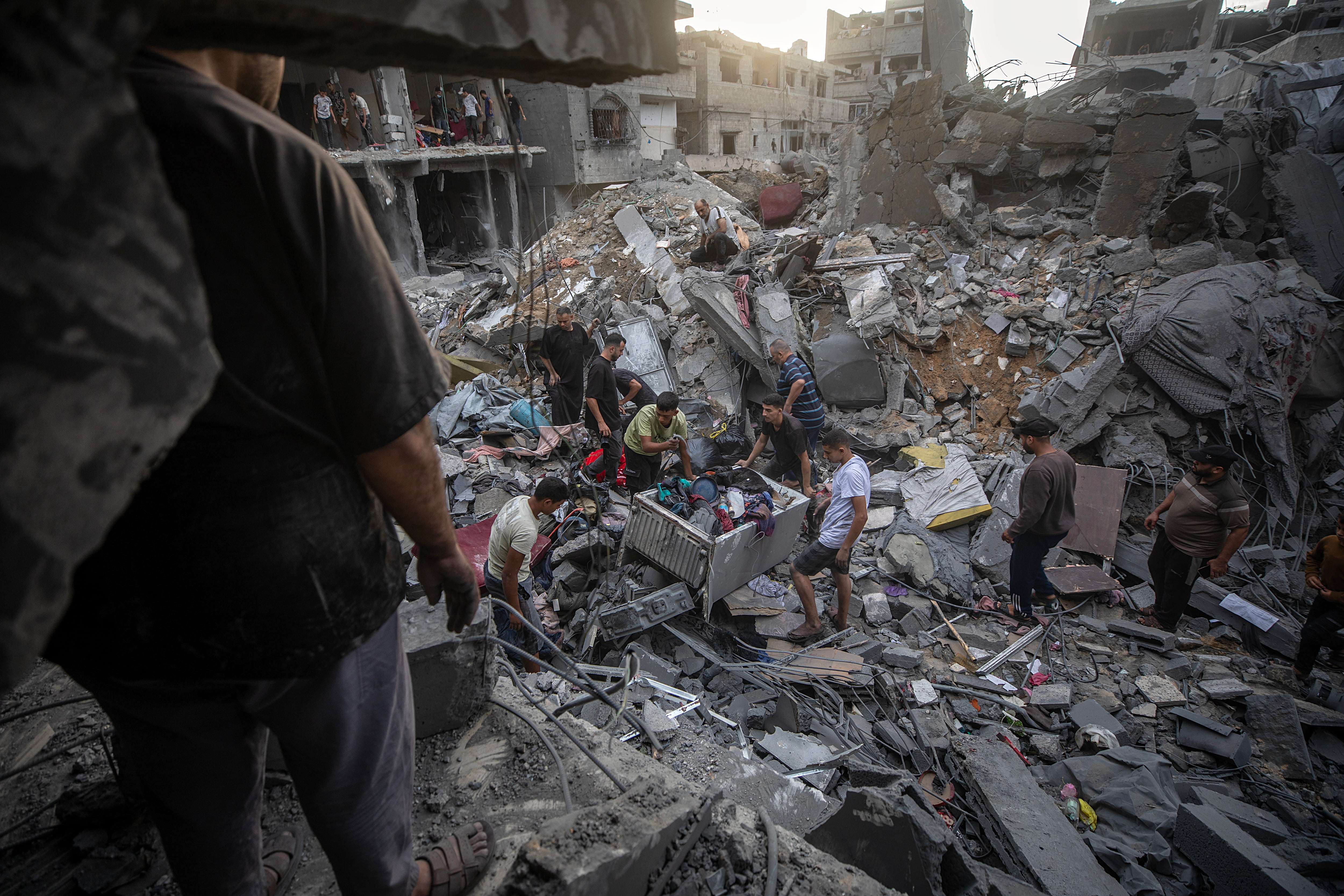 Palestinians inspect the rubble of destroyed homes after an Israeli strike on Gaza city. EPA