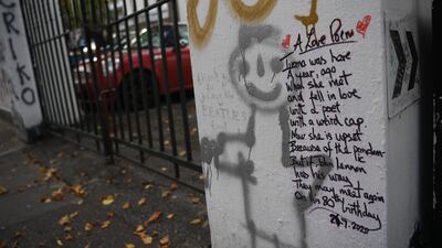 Graffiti commemorating the birthday of John Lennon on the wall of Abbey Road Studios. Music fans come from around the world to pen tributes on the exterior walls. EPA