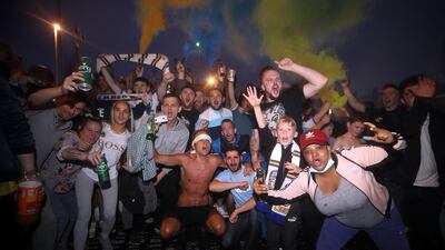 Leeds United fans celebrate outside Elland Road. PA
