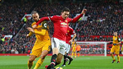 Brighton striker Glenn Murray, left, is shielded off the ball by Manchester United defender Victor Lindelof. Alex Livesey / Getty Images