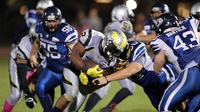 Wildcats player Vivaldi Tulysse, centre, in action during the Desert Bowl between the Dubai Barracudas and the Abu Dhabi Wildcats. Chris Whiteoak / The National