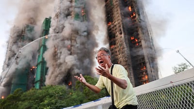 A man worried his wife is trapped inside cries as flames engulf the towers. Reuters