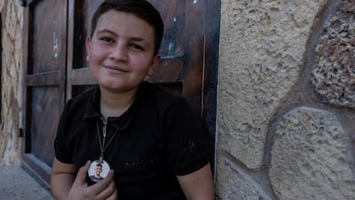 Talal, 13, son of Ayat Abdullah, 31, lost two of his friends in the recent raid on Nur Shams camp. They were his classmates and he now wears their photos around his neck.