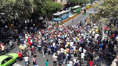 Iranian protestors shout slogans as they gather at a street close to a bazaar in Tehran, Iran, 25 June 2018. EPA/STR