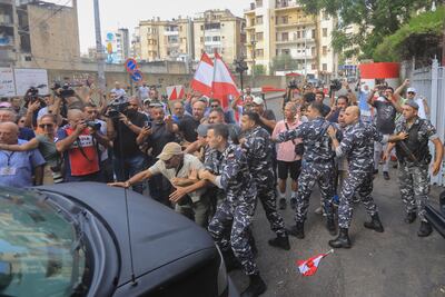 Protesters try to block security forces convoys entering the Palace of Justice in Beirut, where the hearing in the case of Lebanon's former Central Bank chief Riad Salameh began. AFP