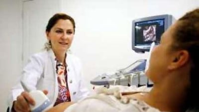 Dr Kubra Taman examines an expectant mother.