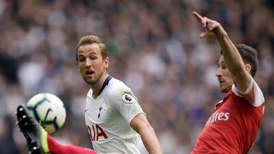 Arsenal's Laurent Koscielny, right, duels for the ball with Kane. AP Photo
