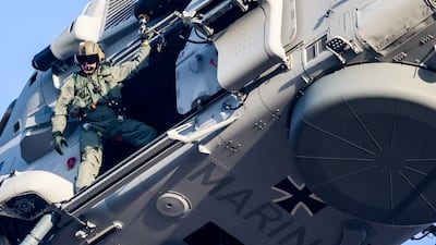 A crew member looks out of the German Navy's first Sea Tiger NH90 MRFH helicopter during delivery to the Ministry of Defence in Berlin. EPA