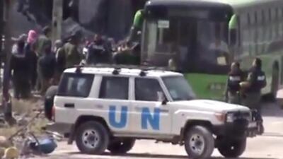 A grab from amateur video footage released by Ugarit News shows Syrian rebels boarding a bus to leave Homs on May 7, 2014. Ugarit News / AP Photo