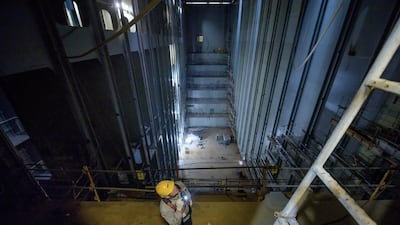 A worker inspects a container hold beneath the decks of an under-construction Maersk triple-E class container ship. Ed Jones / AFP