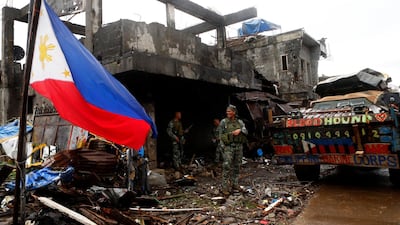 Filipino soldiers rest inside a damaged building in the ruined city of Marawi. The Philippines hailed on Wednesday Washington's decision to blacklist two local pro-ISIL groups, including one which occupied the southern city of Marawi last year. Joeffrey Maitem / EPA