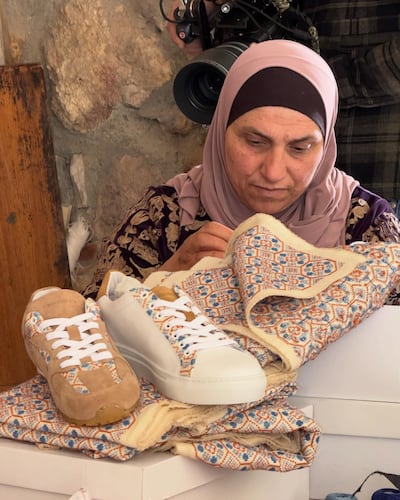 A woman from the Women's Weaving Co-operative of the Palestinian South Hebron Hills works on embroidery for the Resolute RGL trainers. Photo: Resolute RGL