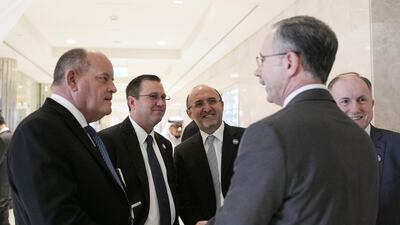 From left, Boeing’s David Copeland, director of payloads and flight integration, and Peter McGrath, director of global sales and marketing at Boeing Space Exploration, with Fakher Daghestani, director of internal corporate communications for India, the Middle East and Africa at Boeing International Corporation, speak with Raymond Handy, foreground, director of business development at Boeing Aerospace Middle East in Abu Dhabi. Philip Cheung for The National