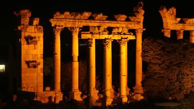 The ruins of the Roman era Heliopolis of Baalbeck is illuminated in orange on the occasion of International Women's Day, in the Lebanese Bekaa Valley. AFP