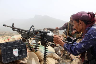 A Yemeni pro-government fighter fires a machinegun on the frontline of Kirsh between the province of Taez and Lahj, southwestern Yemen, on July 1, 2018. AFP Photo