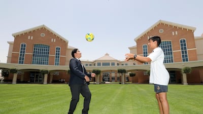 Khalid Alkamali, 14, left and Dhruv Parekh, 10, play football at Repton School on Sunday. Chris Whiteoak / The National