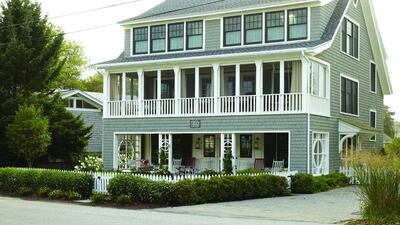 In keeping with traditional summer homes, the porch and white picket fence on this Hampton Beach property hark back to the owner's memories of happy childhood holidays. Laura Moss / Red Cover
