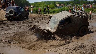 A 4x4 forces its way through the mud. EPA