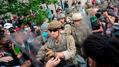 Protesters scuffle with members of the US Army as they demonstrate against the death of George Floyd, near the White House on June 3, 2020 in Washington, DC. AFP