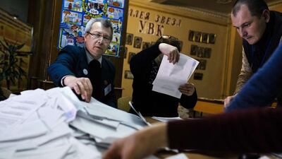 Electoral workers count ballots for the leadership vote in the self-declared Donetsk People's Republic and Lugansk People's Republic at a polling station in the eastern Ukrainian city of Donetsk (AFP PHOTO / DIMITAR DILKOFF)