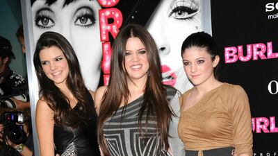 Kylie Jenner, in a brown Bebe dress, with sisters Khloe Kardashian and Kendall, arrive at the premiere of 'Burlesque' at Grauman's Chinese Theatre on November 15, 2010. AFP