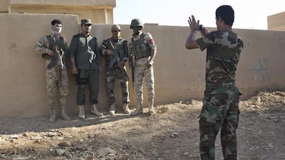 Peshmerga fighters stop for a picture before they prepare to leave their base in Makhmor, Iraq, for the nearby front line.