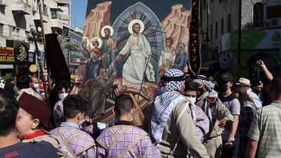 Palestinians parade in the streets of Ramallah to celebrate the arrival of the Holy Fire on May 1, 2021, as Orthodox Christians mark Great Saturday ahead of Easter. AFP