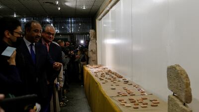 Iraqi Culture Minister Hassan Nadhim looks at ancient artefacts handed over by Lebanon to Iraq on display at the National Museum in Baghdad on February 8, 2022. Reuters