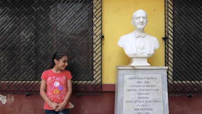 A pupil with a bust of one of the founders of the school. Courtesy Jenny Gustafsson
