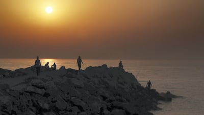 People at a beach in Ras Al Khaimah. Pawan Singh / The National