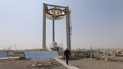An employee walks at a solar plant in Masdar City outside Abu Dhabi. Masdar City is at the forefront of the UAE’s efforts to focus on renewables. Karim Sahib / AFP