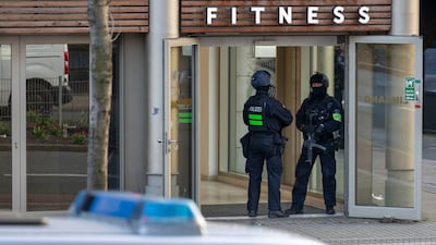 Armed police officers outside the gym in Duisburg, Germany, where four people were injured in an attack. AP