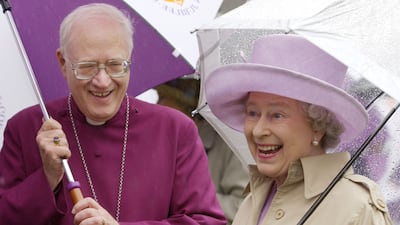 Queen Elizabeth II with then Archbishop of Canterbury, Lord George Carey, at his royal garden party at Lambeth Palace, London, in June 2002. PA