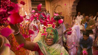 Indian Hindu widows throw flower petals and colored powder during Holi celebrations at the Gopinath temple, India. A few years ago this joyful celebration was forbidden for Hindu widows. Like hundreds of thousands of observant Hindu women they would have been expected to live out their days in quiet worship, dressed only in white, their very presence being considered inauspicious for all religious festivities. Manish Swarup / AP