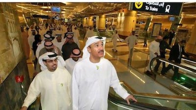 Hussain Nasser Lootah, right, the director general of Dubai Municipality, rides the Metro escalator with other officials.