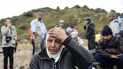 Syrian refugees wait on the Greek island of Lesbos after crossing the Aegean Sea from Turkey on November 16, 2015. European leaders tried to focus on joint action with Africa to tackle the migration crisis, as Slovenia became the latest EU member to barricade its borders. Bulent Kilic / Agence France-Presse