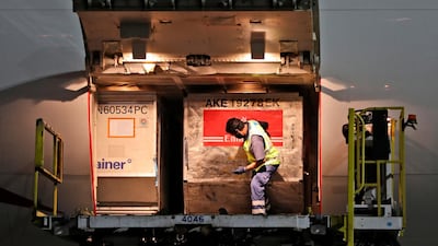 Covid-19 vaccines are offloaded from an Emirates aircraft at Dubai International Airport. Emirates is a key partner in the Covax scheme providing free vaccines to poorer countries. AP Photo