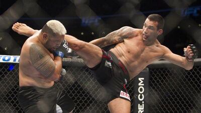 Fabricio Werdum of Brazil, right, kicks Mark Hunt of New Zealand, left, in his win for the UFC interim heavyweight title on Saturday night at UFC 180 in Mexico City. Christian Palma / AP / November 15, 2014