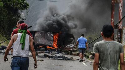 Venezuelan opposition activists set up barricades during a demonstration against President Nicolas Maduro in San Cristobal. George Castellanos / AFP Photo